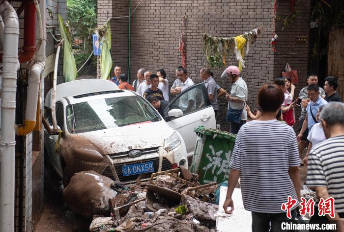 7月4日，萬(wàn)州區(qū)五橋街道，居民救援受困的私家車(chē)?！∪矫宪?攝