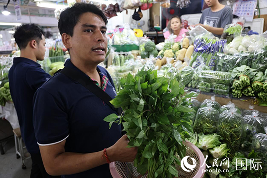 7月19日，泰國(guó)曼谷藍(lán)象餐廳員工向參加活動(dòng)的多國(guó)代表介紹如何挑選新鮮蔬菜。 人民網(wǎng)記者 張矜若攝