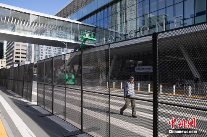 當(dāng)?shù)貢r(shí)間11月10日，一名行人從美國舊金山莫斯康中心周圍的金屬圍欄旁經(jīng)過。隨著亞太經(jīng)合組織(APEC)第三十次領(lǐng)導(dǎo)人非正式會(huì)議臨近，作為會(huì)議場(chǎng)地的莫斯康中心附近出現(xiàn)金屬圍欄，執(zhí)勤警察也大幅增加。<a target='_blank' href='/'><p  align=