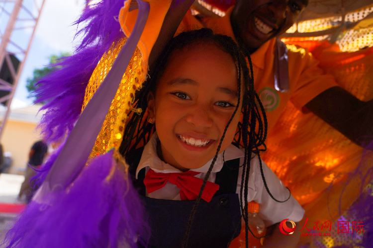 一名小朋友在與舞獅表演者互動。人民網記者 黃煒鑫攝