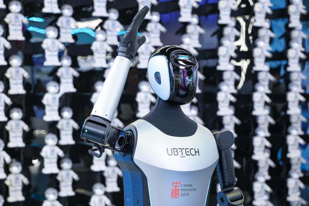 △ 2025年4月23日，在深圳優(yōu)必選科技展廳內(nèi)，商用版人形機(jī)器人Walker C向觀眾揮手致意。