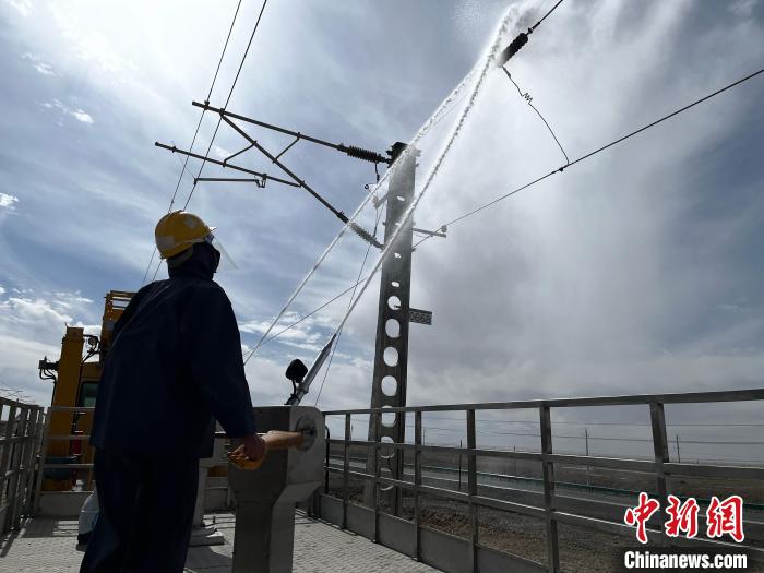 圖為高壓水槍的水柱沖洗絕緣子串?！「邌⒑?攝